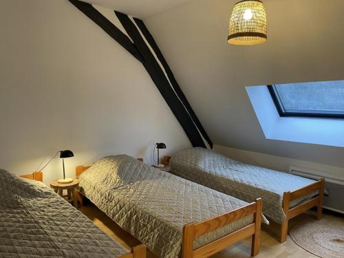a bedroom with two beds and a window at Gîte Saint-Bonnet-Tronçais, 3 pièces, 6 personnes - FR-1-489-415 in Saint-Bonnet-Tronçais