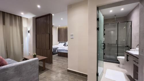 a bathroom with a shower and a toilet and a bedroom at Sky Pyramids View in Cairo