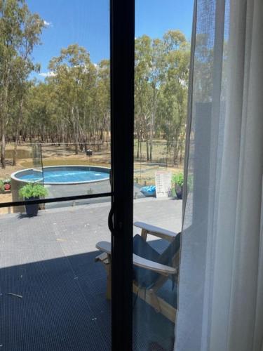 a view of a swimming pool from a window at Tocumwal Chocolate School in Tocumwal