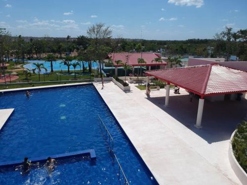 a pool at a resort with a view of a park at Breezy & Cancunian Villa in Cancún