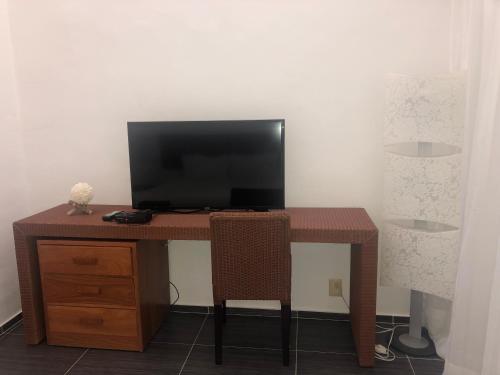a wooden desk with a television on top of it at Vista Mare Spectacular Ocean View Top Floor 1-Bedroom Condo, Samana in Santa Bárbara de Samaná