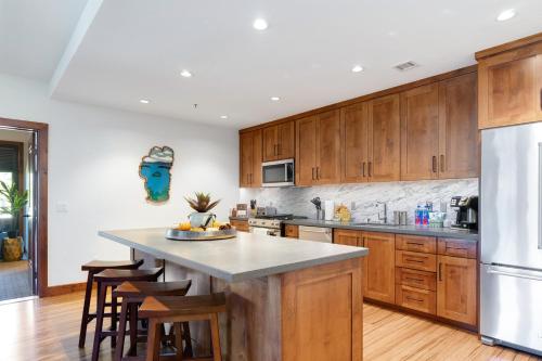 a kitchen with wooden cabinets and a large island at Ultimate Luxury Residence with Extras Galore across from Heavenly Village & Gondola - Zalanta Resort in South Lake Tahoe