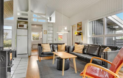 a living room with a couch and a table at Holiday Home Birkemose Ds Dnmk in Skovby