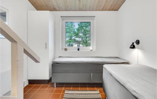 a small room with a bed and a window at Cozy Home In Sæby With Sauna in Sæby