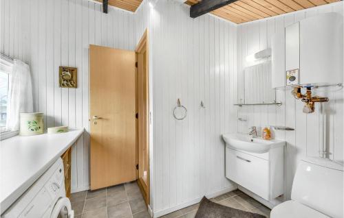 a white bathroom with a sink and a toilet at Sommervind in Falen