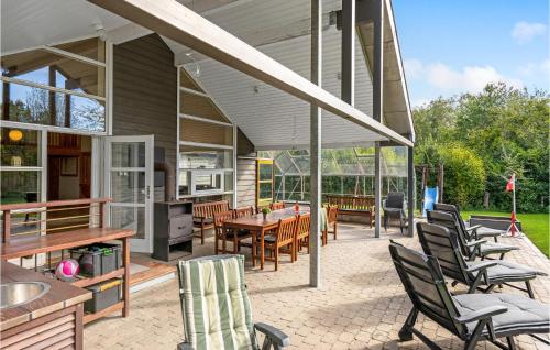 an outdoor patio with chairs and a table and a tablektop at Holiday Home Hadsund 02 in Hadsund