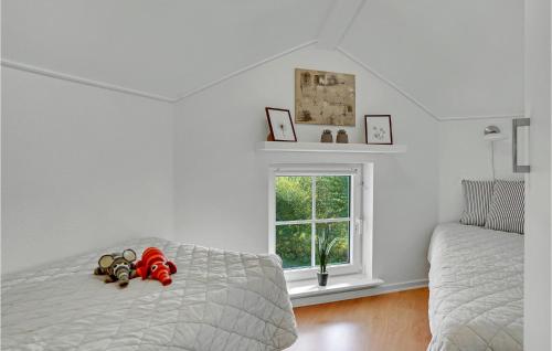 a bedroom with a bed with two stuffed animals on it at Nice Apartment In Bogense With Wifi in Bogense
