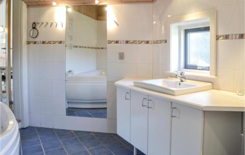 a bathroom with a sink and a toilet and a tub at Lrken in Vejers Strand