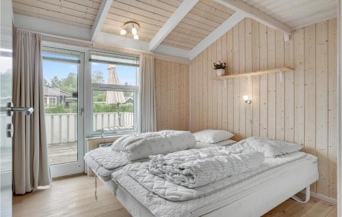 a bedroom with a bed and a large window at Birkely in Nyborg