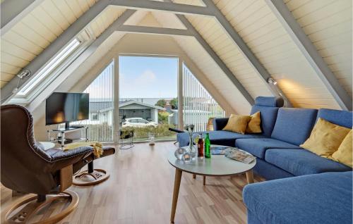a living room with a blue couch and a table at Amazing Home In Bogense With Sauna in Bogense