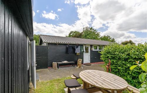 a patio with a table and chairs and a building at Gorgeous Home In Farsø With Kitchen in Farsø