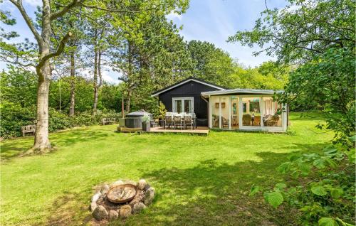 a tiny house in the middle of a yard at 2 Bedroom Awesome Home In Farsø in Farsø