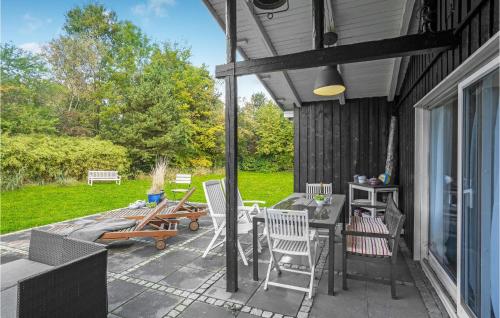a patio with chairs and a table and a table and chairs at Stunning Home In Vig With Wifi in Vig