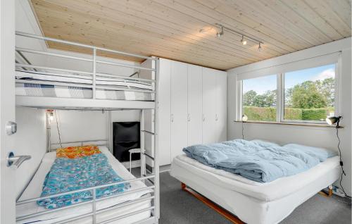 a bedroom with two bunk beds and a window at Pet Friendly Home In Vinderup With Sauna in Vinderup