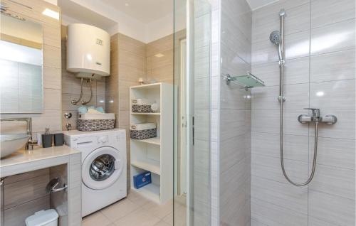 a bathroom with a washing machine and a shower at Stunning Apartment In Kostrena With Kitchen in Kostrena