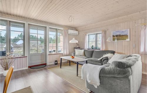 a living room with a couch and a table at Holiday Home Thadesvej Rømø X in Toftum