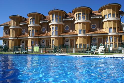 a large building with a pool in front of it at Apartamentos Quinto Sueño in Noja