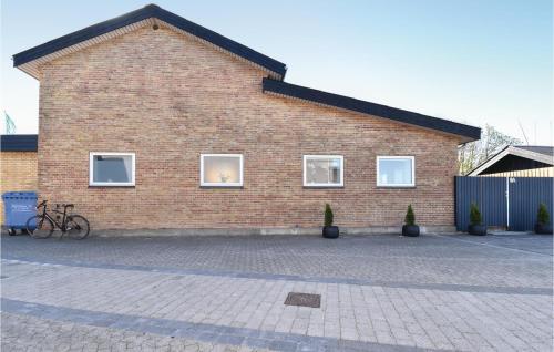 a brick building with a bike parked in front of it at Det Gamle Gasværk in Bogense