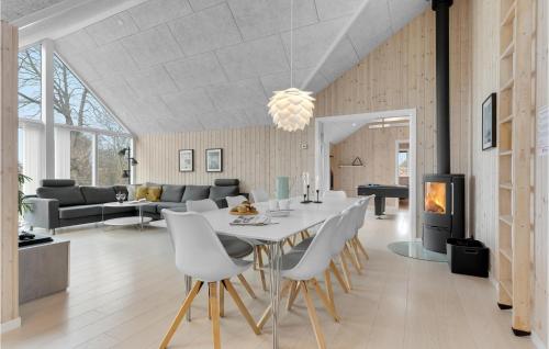 a dining room and living room with a table and chairs at Four-Bedroom Holiday Home In Odder in Odder