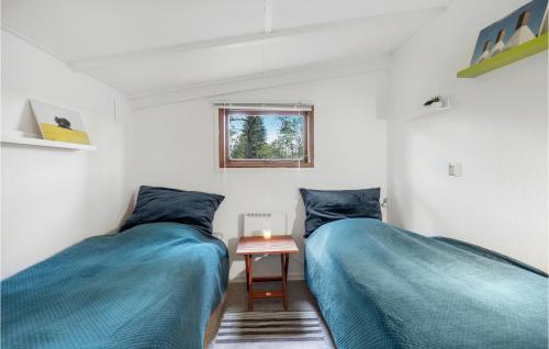two beds in a room with blue sheets at Beautiful Home In Nex With Kitchen in Neksø