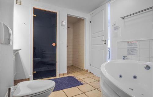 a bathroom with a white tub and a toilet at Gorgeous Apartment In Nykbing Sj With Wifi in Nykøbing Sjælland