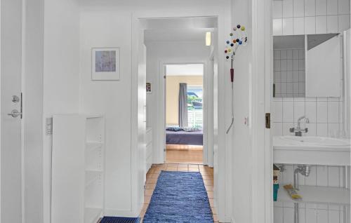 a white hallway with a sink and a bathroom at Cozy Apartment In Rudkøbing in Rudkøbing