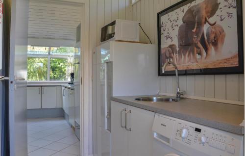 a kitchen with a sink and a counter top at Holiday Home Bl in Dronningmølle