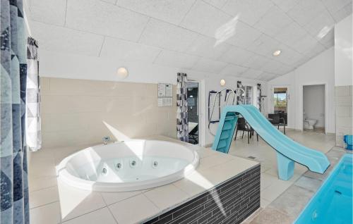 a large bathroom with a tub and a slide at Amazing Home In Nordborg With Sauna in Nordborg