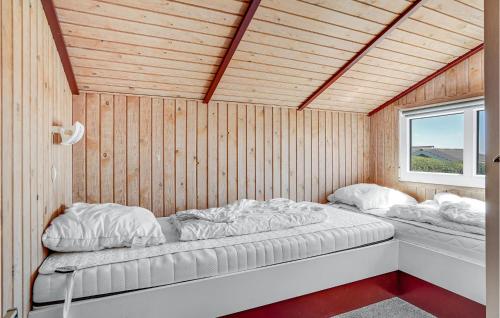 a bedroom with two beds in a wooden wall at Gorgeous Home In Sjlund With Wifi in Hejls
