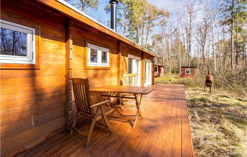 a wooden deck with a table and chairs on a cabin at Pet Friendly Home In Stege in Stege