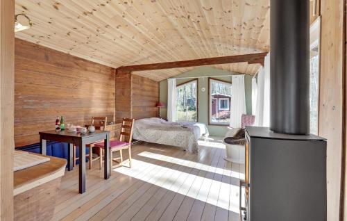 a living room with a wooden ceiling and a table at Pet Friendly Home In Stege in Stege