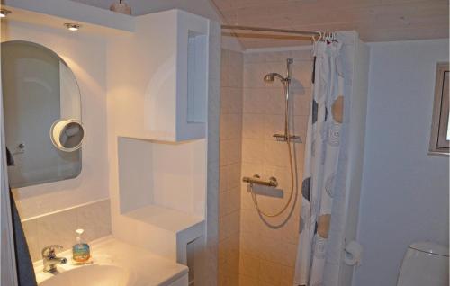 a bathroom with a sink and a shower at Amazing Home In Mesinge With House Sea View in Mesinge