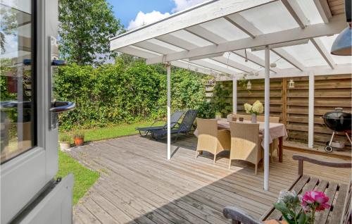 a patio with a table and an umbrella at Holiday Home Midtvej Nexø Iv in Balke