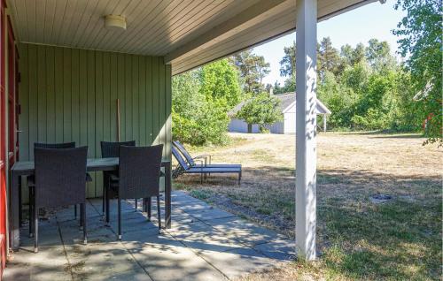 a patio with a table and chairs on a house at 3 Bedroom Stunning Home In Aakirkeby in Vester Sømarken