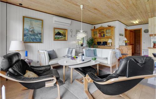 a living room with a table and chairs at Nice Home In Sydals With 3 Bedrooms, Sauna And Wifi in Skovby