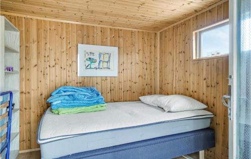a small bedroom with a bed in a wooden wall at 3 Bedroom Pet Friendly Home In Vig in Vig