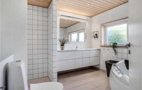a bathroom with a toilet and a sink and a mirror at Amazing Home In Glesborg With Kitchen in Glesborg
