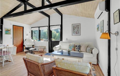 a living room with a couch and a table at Three-Bedroom Holiday Home In Rodby in Rødby