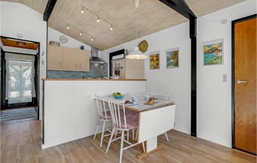 a kitchen with a table and chairs in a room at Three-Bedroom Holiday Home In Rodby in Rødby