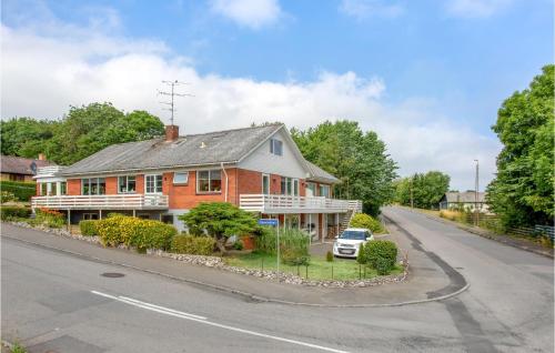 a red and white house on the side of a road at 1 Bedroom Cozy Apartment In Allinge in Allinge