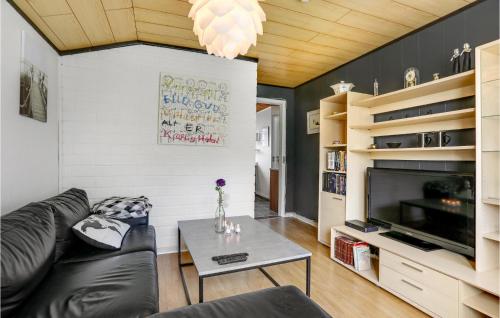 a living room with a couch and a table at 1 Bedroom Cozy Apartment In Allinge in Allinge