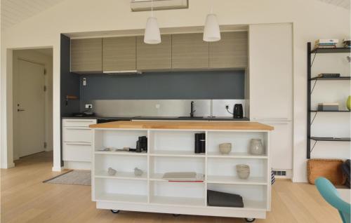 a kitchen with white cabinets and a counter at Three-Bedroom Holiday Home In Skals in Skals