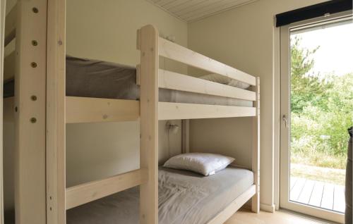 SkalsにあるBeautiful Home In Skals With Wifiの窓付きの客室の木製二段ベッド1台分です。