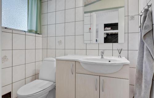 a white bathroom with a sink and a toilet at Imagine in Bedegård