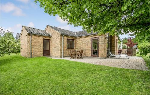 a brick house with a patio in the yard at Three-Bedroom Holiday Home In Ebeltoft in Ebeltoft