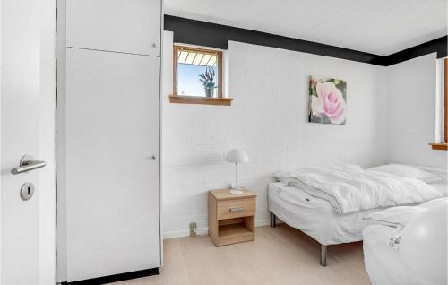 a bedroom with a bed and a table and a window at 3 Bedroom Cozy Home In Frørup in Frørup