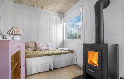 Zimmer mit einem Herd und einem Bett mit einem Fenster in der Unterkunft Stunning Home In Frevejle With House Sea View in Fårevejle