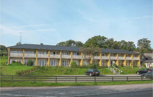 a large yellow building on the side of a road at Beautiful Apartment In Allinge in Allinge