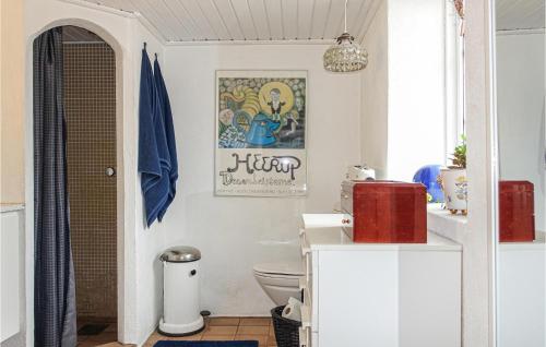 a bathroom with a white toilet in a room at Beautiful Apartment In Nex With Wifi in Neksø