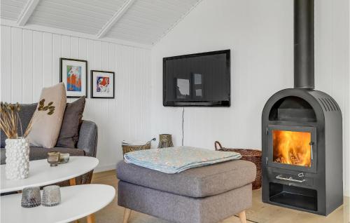 a living room with a wood stove in a room at Holiday Home Blåvand Strand Blåvand X in Blåvand